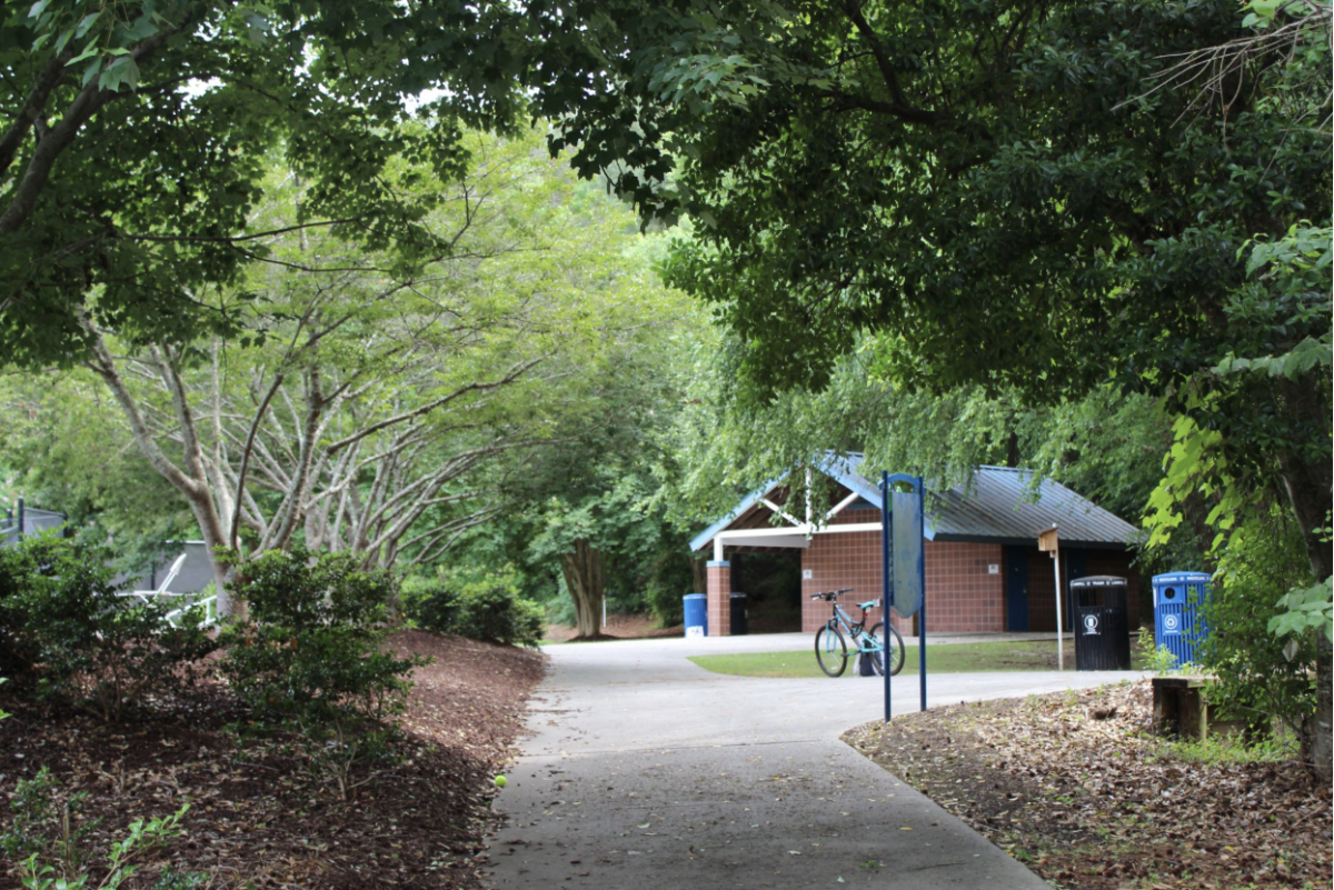 The entrance to Cary Tennis Park feels like a breath of fresh air with its wooded paths and sounds of wildlife surrounding tennis players enjoying a break from work. Bikers and joggers can be seen moving around the park. 