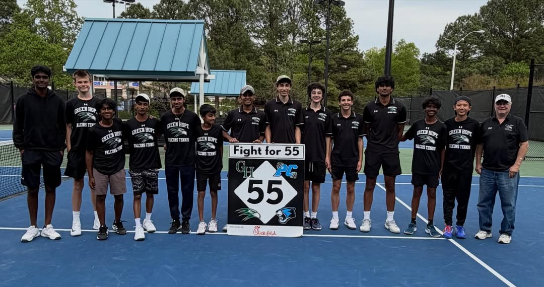 Stephen Gervase (‘26), along with the rest of the Men’s Tennis team, stands behind the "Fight for 55" banner after a 9-0 victory over Panther Creek. Permission provided by Green Hope Athletics.